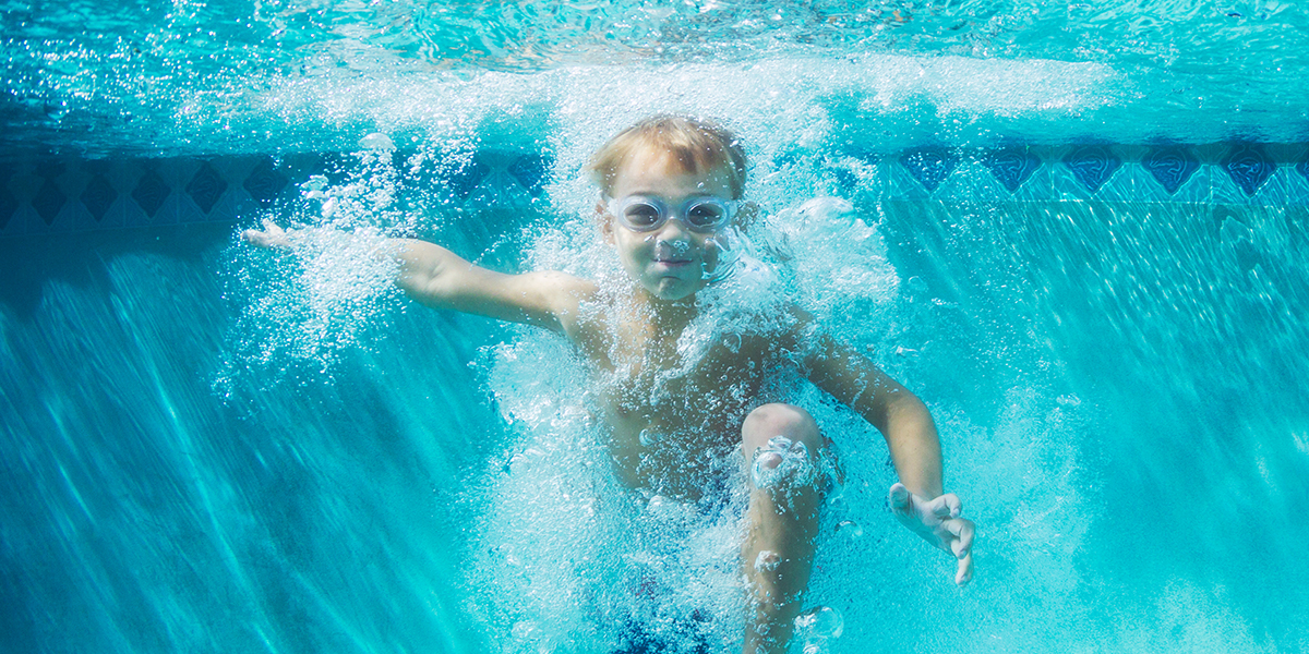 Boy making a splash with swim school management software